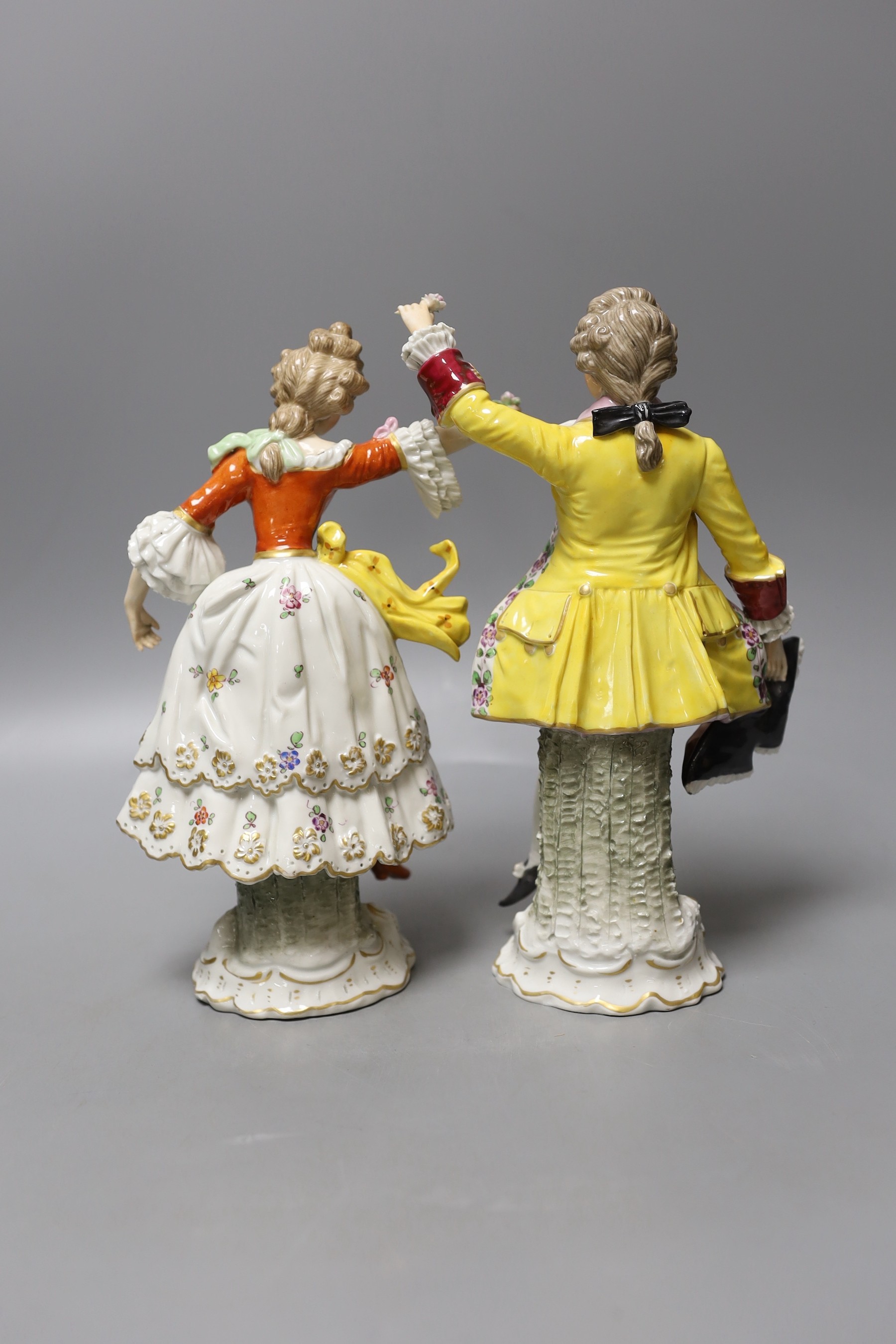 A pair of Naples porcelain figures - tallest 23cm